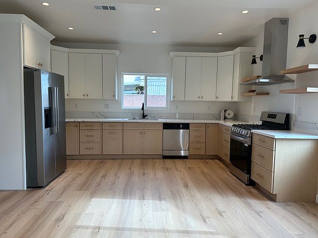 Spacious full kitchen with slim shaker cabinets, 30in gas range, dish washer, refrigerator and freezer.