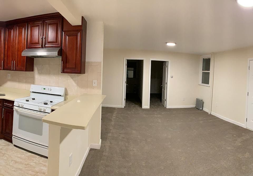 Here is a panoramic view of the kitchen and living/dining space. The door to the right is 1 of the 2 entry points to the home and the two open doors straight ahead are bedroom #2 and #3. Directly behind this perspective is bedroom #1 (master bedroom).
