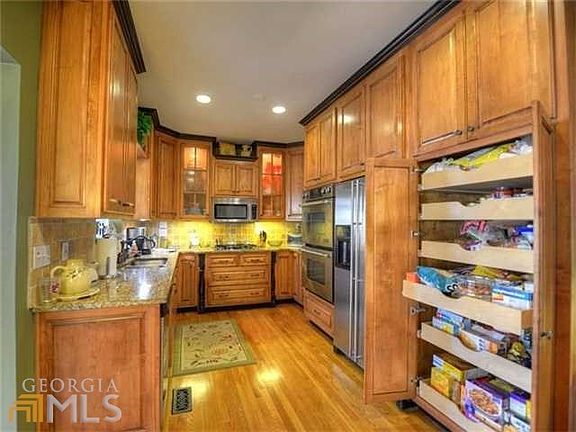 Another view of the gorgeous kitchen featuring pull out drawers in the pantry!