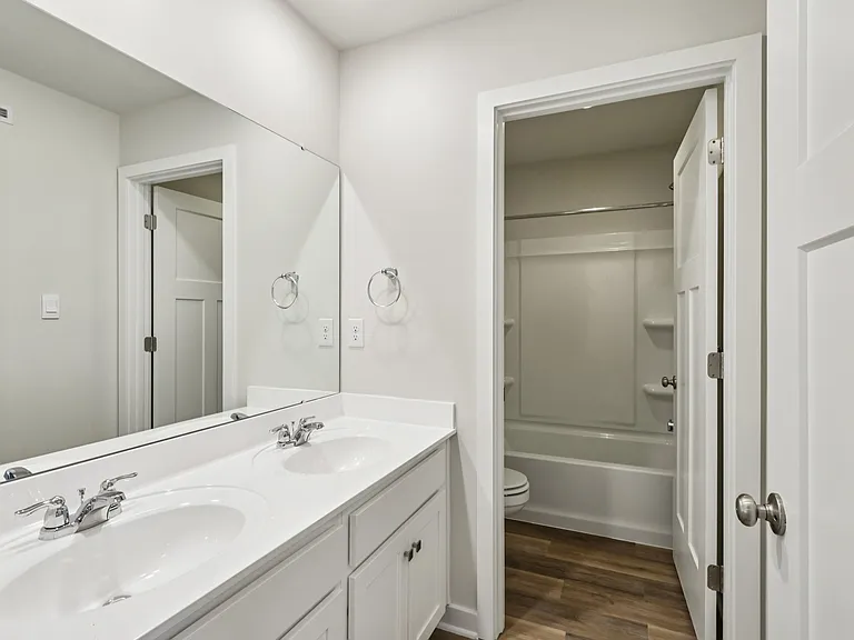 Hallway bathroom (designed for dual use) - dual vanity with cultured marble