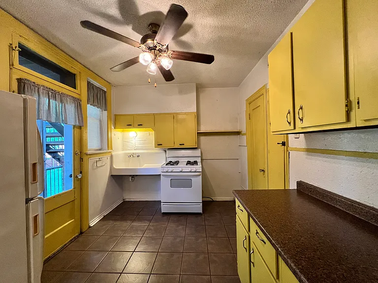 Through a swinging door, you enter into the bright and cheery kitchen!