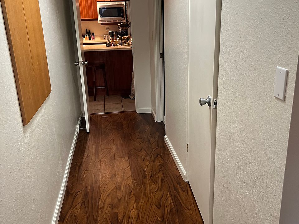 Hallway in bedroom leads to master bath and closets on right and left Kitchen just outside bedroom
