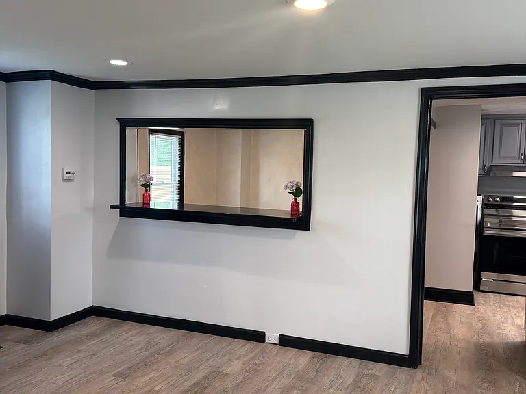 Living room with recess lighting and serving hatch leading to the dining room