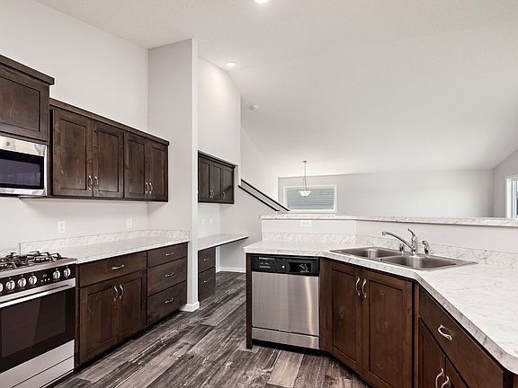 The open kitchen features stunning cabinets, a spacious breakfast bar and huge pantry.