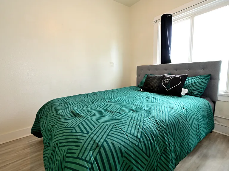 spacious and bright bedroom with furnishings + brand new ceiling fans and mini split AC