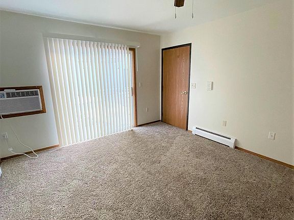 Living Room has in wall A/C with heater. Apartment has new Carpet, Ceiling Fan & Patio Door Blinds.