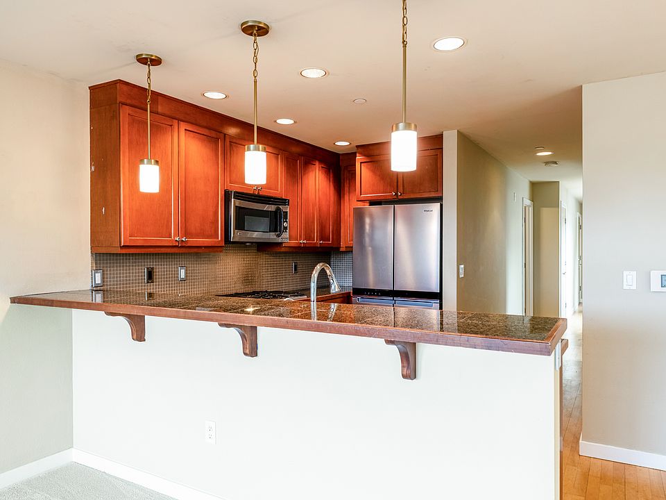 The kitchen bar faces the living room.