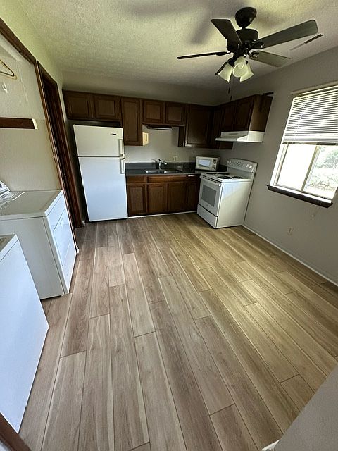 Kitchen, quartz countertops, new flooring throughout, washer and dryer provided in unit (closet area)