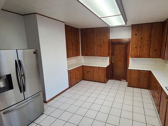 Large kitchen with stainless steel refrigerator included with tons of cabinets & counter space.