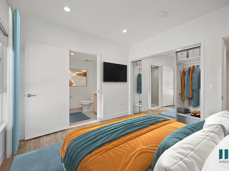 Bedroom with Closet with Built-In Shelving, Bathroom, and Large-Size Windows