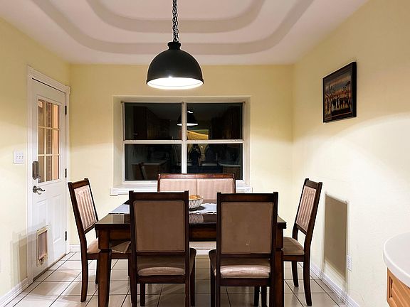 cozy dining overlooking fenced backyard