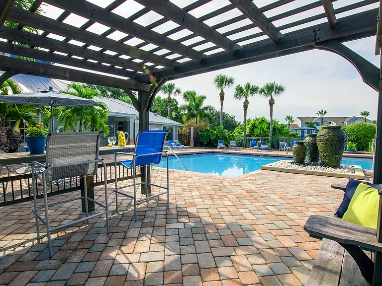 Escape to our poolside pergola, where dappled sunlight dances through the lattice and invites you to relax and unwind.