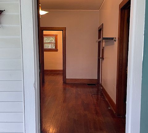 Standing on front porch looking into main tv room. Door from on the right leads into main bedroom. Door frame on the right (middle of picture) leads into the kitchen. Door frame straight ahead leads into office.