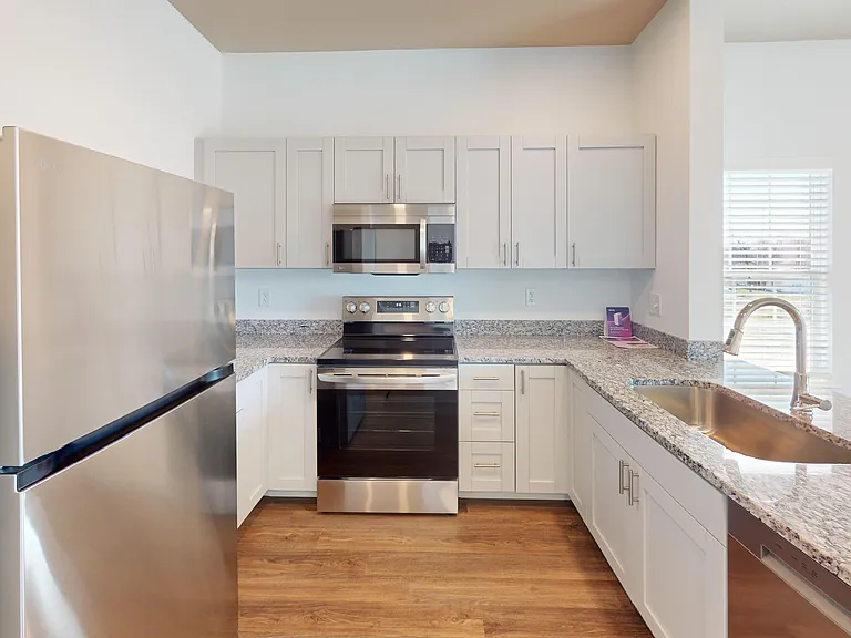 The Roth kitchen features granite countertops, a breakfast bar, and stainless steel appliances, including a glass-top stove, microwave and dishwasher. The Roth kitchen features granite countertops, a breakfast bar, and stainless steel appliances, includin