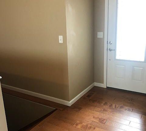 Front door and stairs to basement