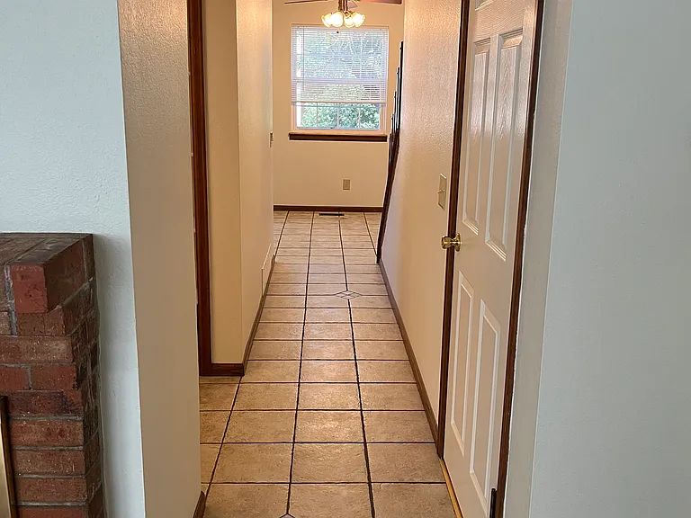 Main floor hallway with tile flooring