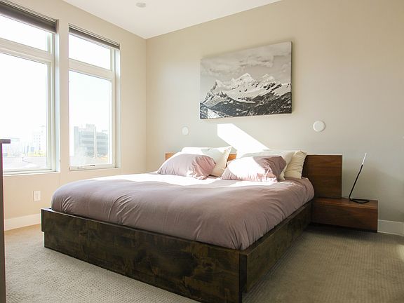 The master bedroom has luxurious plush king-size matres, black-out curtains, a dresser, and an attached master bath with a walk-in closet.
