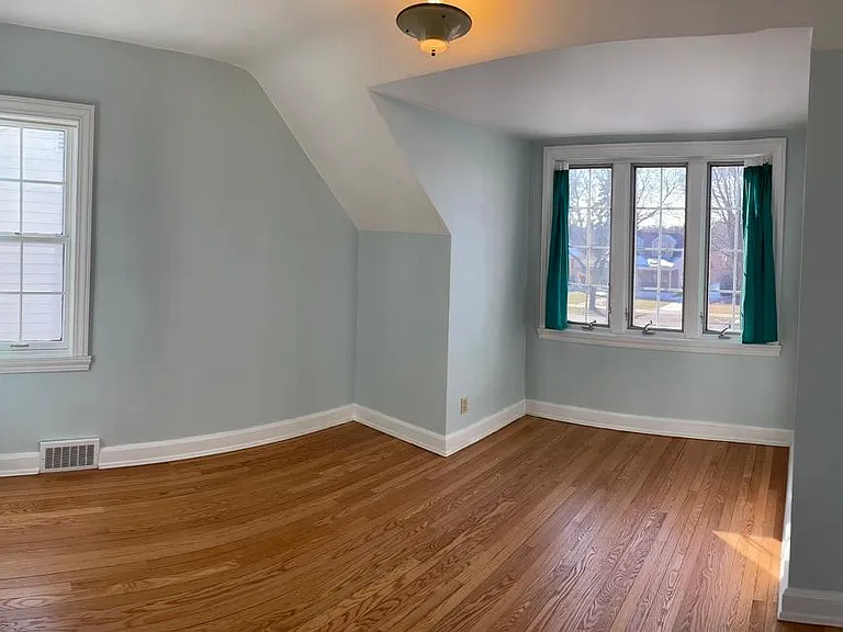 Second floor bedroom w/ west and south view windows and deep closet with shelves.