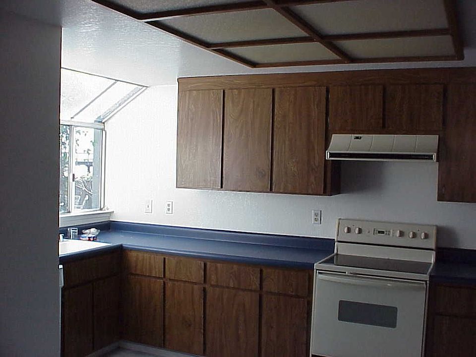 the kitchen with a huge window on the left looking out on the water