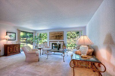 Generous sized living room with an Avalon gas fireplace with tile surround & glass slider out to dec