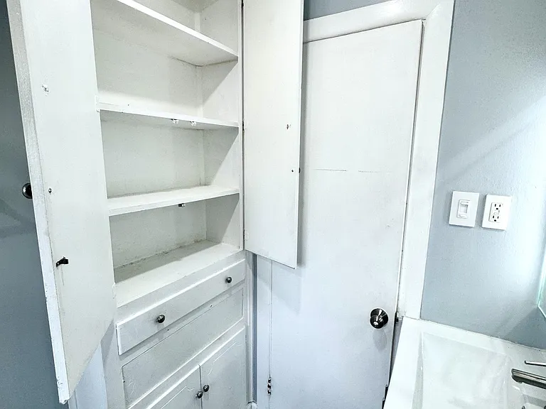 Bathroom with dimmable lighting and ample storage.