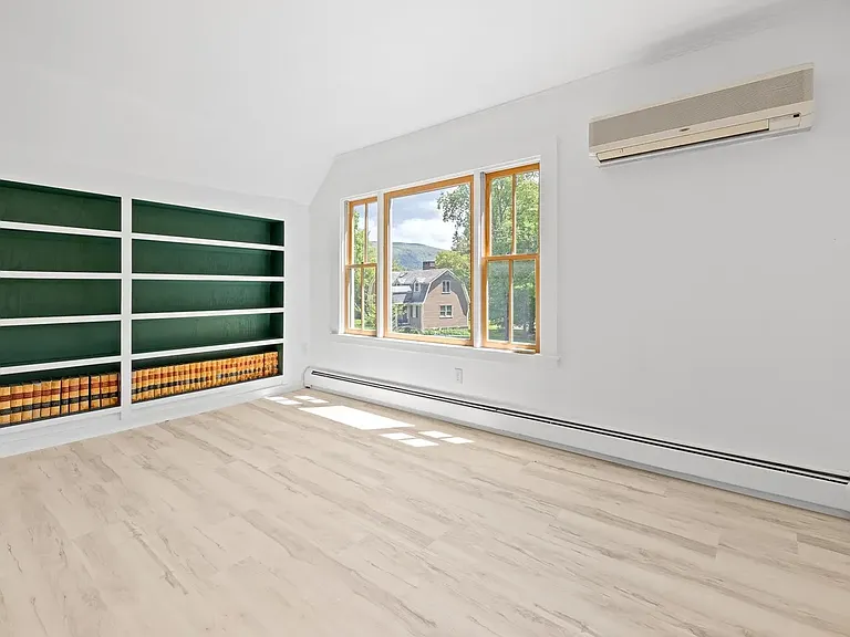 Living Room and Wall Air Conditioning Unit - Second Floor. The large, South facing window fills this room with light.