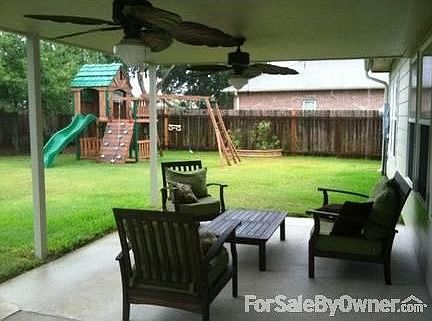 Backyard with covered patio and playset
