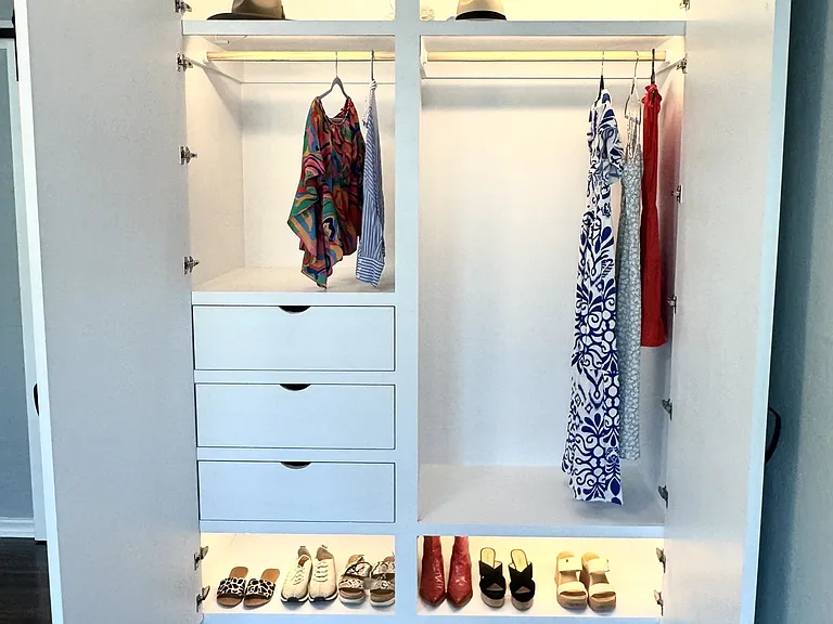New custom oversized closet with double hanging section, upper shelf, deep drawers, shoe shelf, and motion lighting.
