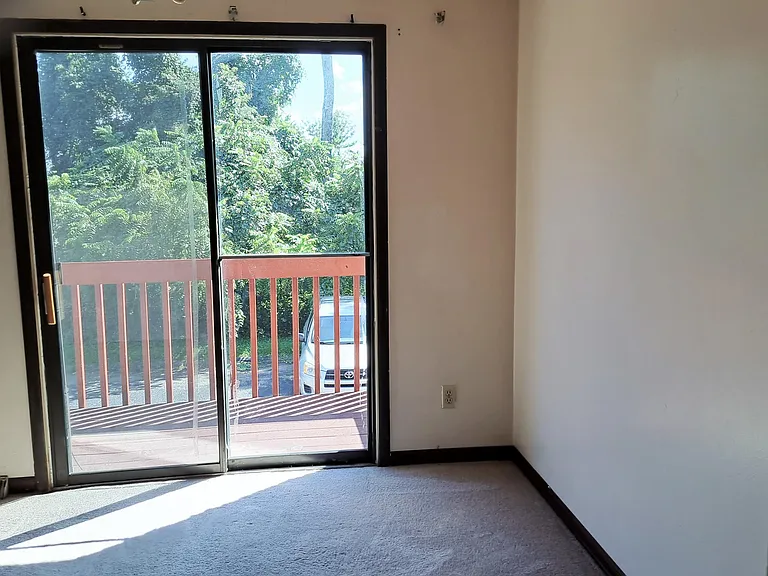 Dining area with view of private deck and additional parking for second car and guest cars