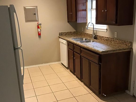 Kitchen view of sink and dishwasher.