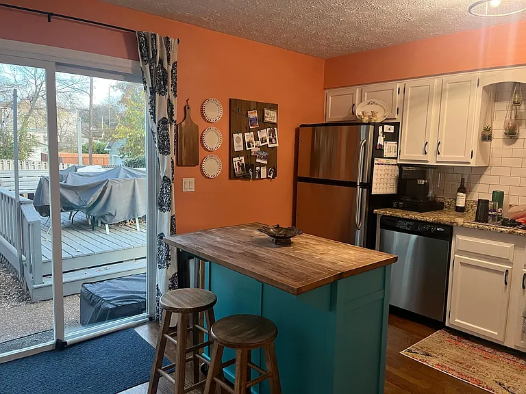 Kitchen, sliding door into fenced backyard. (13x12)