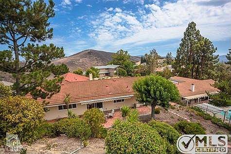 Drought tolerant natural landscaping and an abundance of trees complete this beautiful setting.