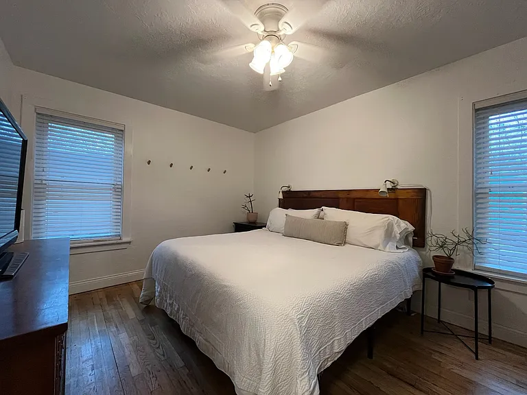 Bedroom 1 / Furnished with king-sized bed, dresser, and TV