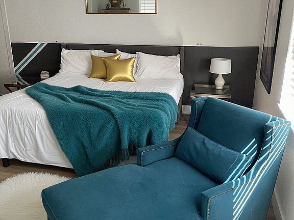 Primary bedroom with King size bed and private bathroom and sitting area