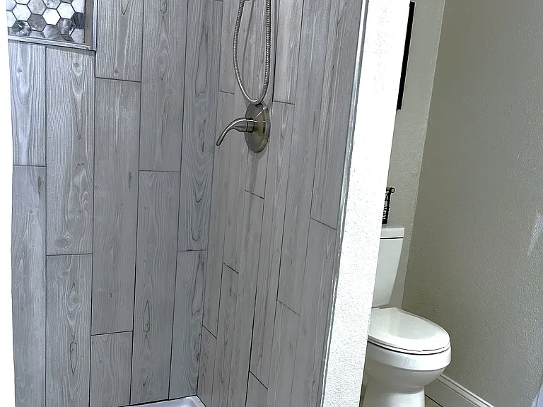 Spacious bathroom with oversized shower and vanity for storage