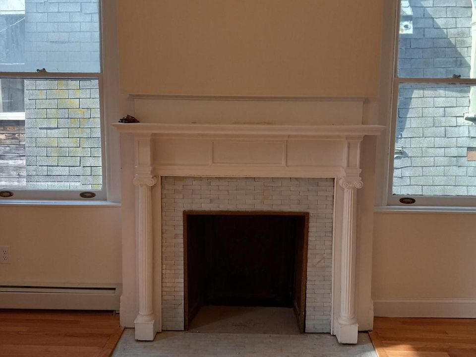 The duplex has many architectural details including two decorative fireplaces, outdoor deck, red oak hardwood flooring and wall moldings.