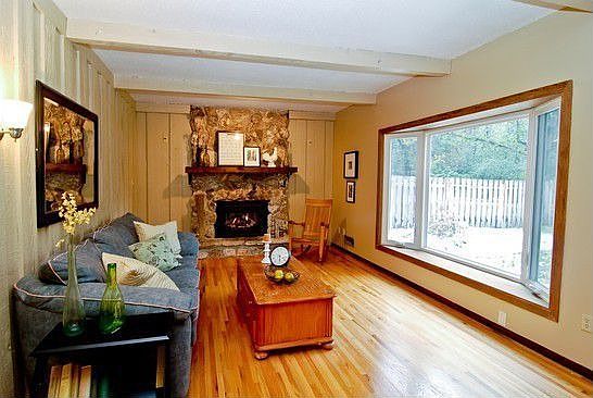 Family room with new gas fireplace and bow window overlooking the Koi pond