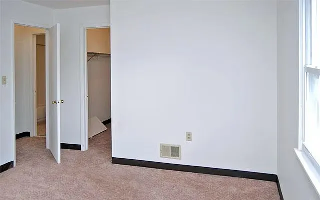 Bedrooms are carpeted in a neutral color.