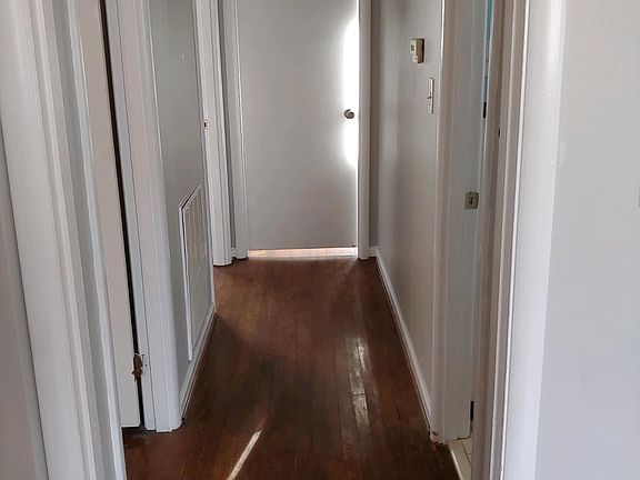 Hallway. 
Two bedrooms to the left, one straight ahead, bathroom to the right.