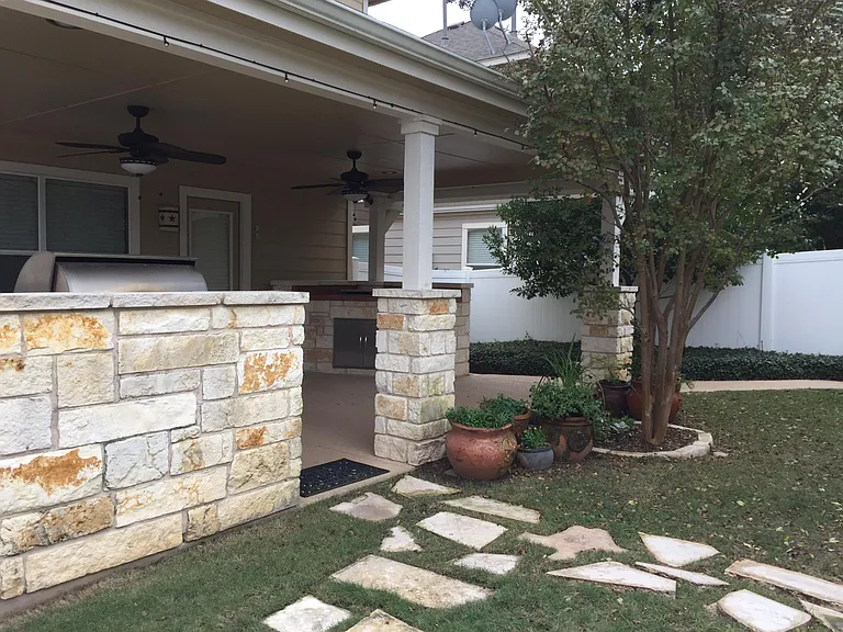 Lush Green Lawn with Stone Walkway by Outdoor Kitchen/Patio