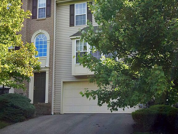 The driveway is full sized with two car garage