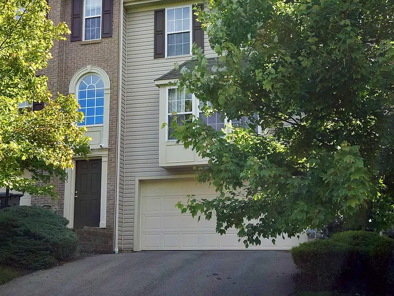 The driveway is full sized with two car garage