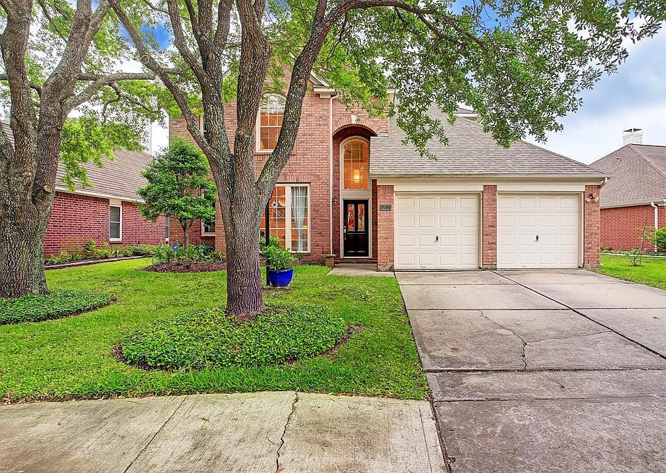 Located in a gated community, this 4-bedroom home has mature trees and is located on a cul-de-sac.