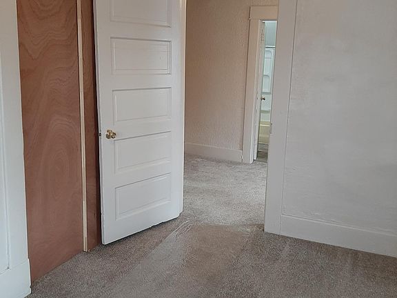 larger bedroom looking toward smaller bedroom and bathroom