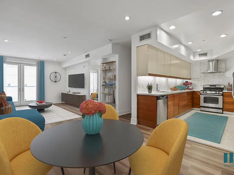 Open-Concept Kitchen, Dining, and Living Room with Patio