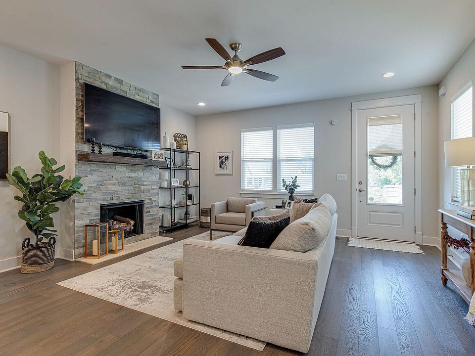 Large living space with gas fireplace and lots of natural light. Open floor plan to the kitchen