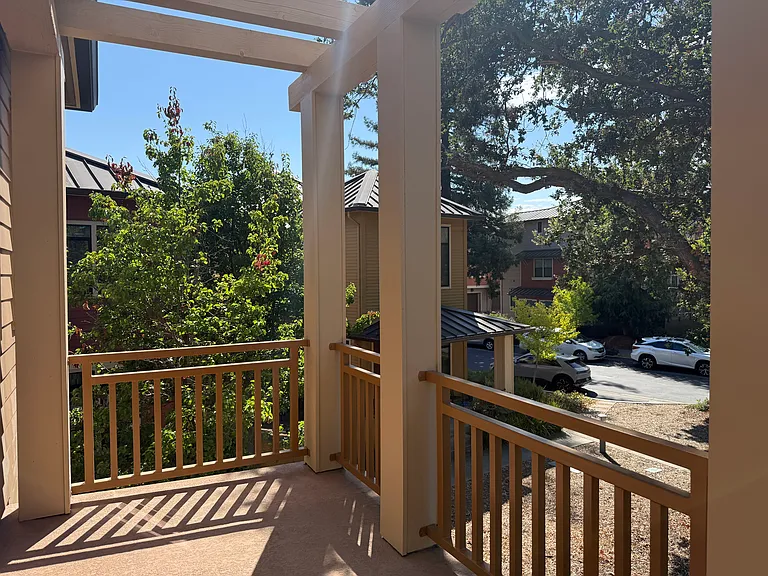 Primary bedroom has a patio door that opens a balcony overlooking the community green belt.