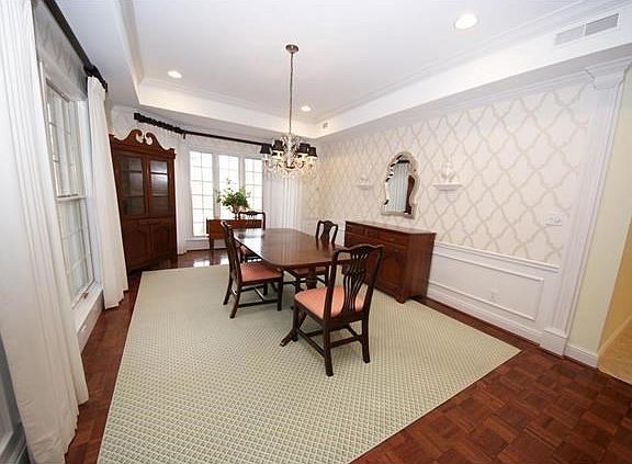 Formal Dining Room has bay window, chandelier, and designer wallpaper.