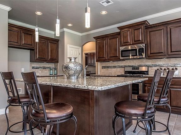 The kitchen also features a beautiful lighting package, a sizable pantry and additional bar space so guest can pull up a chair and visit.