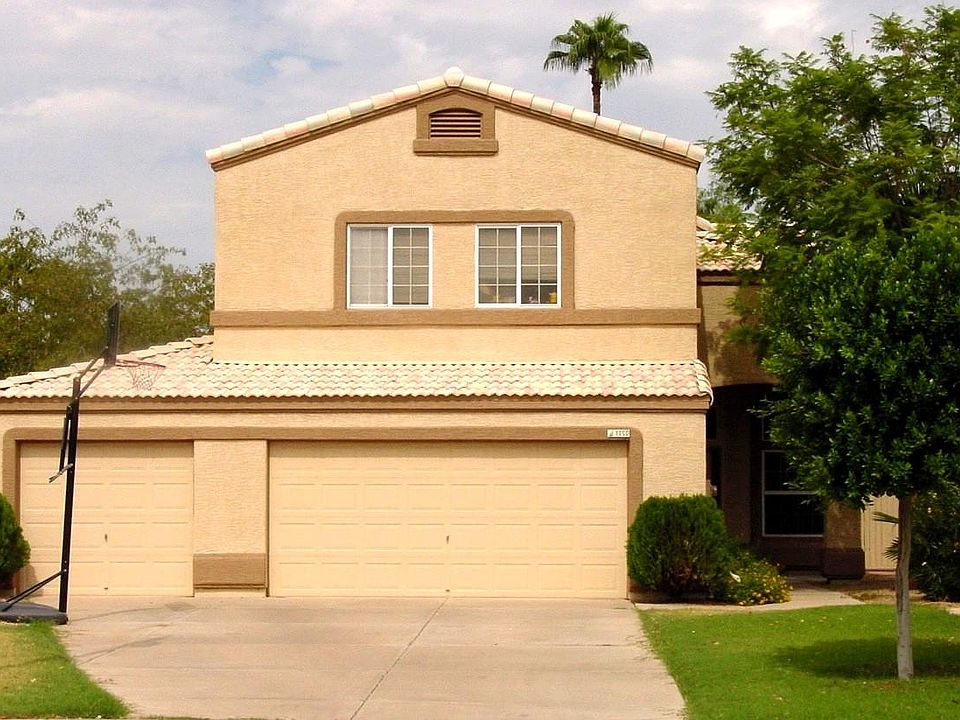 A picture of the house right after it was painted a few years ago and the sun was shining brightly on it.
